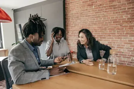 Three people eating together at a table